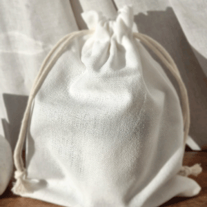 Cotton pouch with candle inside, beautiful natural cotton drawstring bag